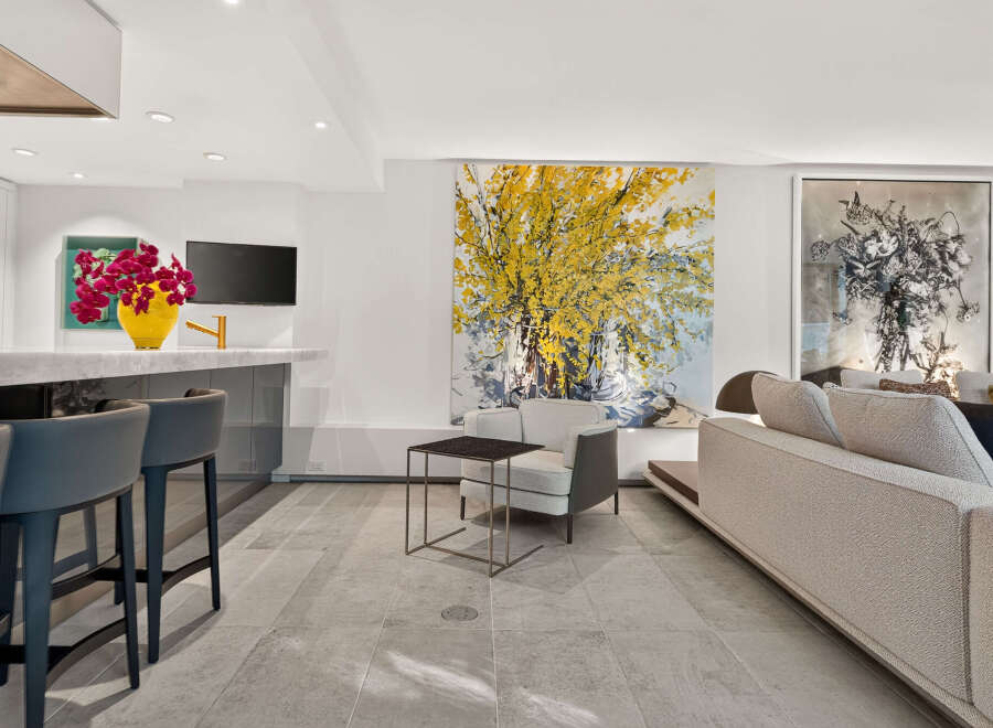 Experience modern living in this open-concept space, featuring a sleek kitchen island with bar seating and a spacious living area.
