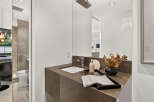 Experience modern luxury in this stunning bathroom, featuring a sleek vanity with a stone countertop and a vessel sink.