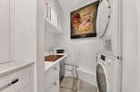 This laundry room offers a practical and stylish setup with a stacked washer and dryer, perfect for maximizing space.