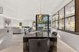 Experience luxury living in this stunning open-plan residence, featuring a sleek dining area with a modern table and chairs, perfect for entertaining.