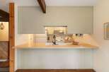 Discover this charming kitchen featuring a spacious butcher block countertop perfect for meal prep and casual dining.
