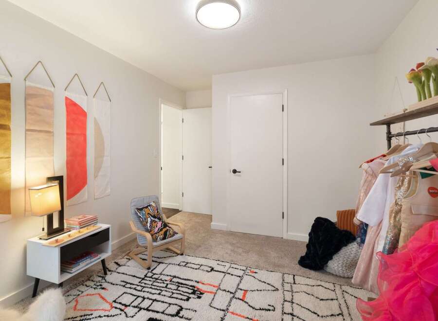 This charming bedroom features a playful and organized space, perfect for a child or creative individual.