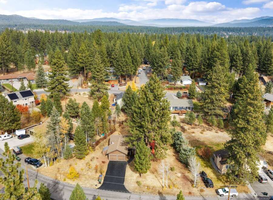 Discover this charming home nestled among mature pine trees, offering a serene and private setting.