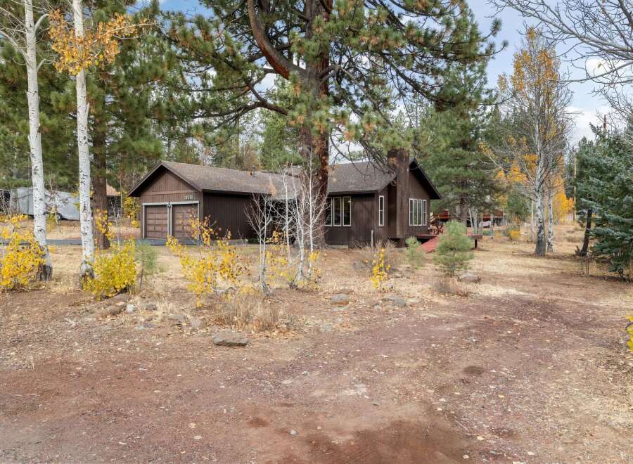 Nestled amongst mature trees, this charming home offers a serene retreat.
