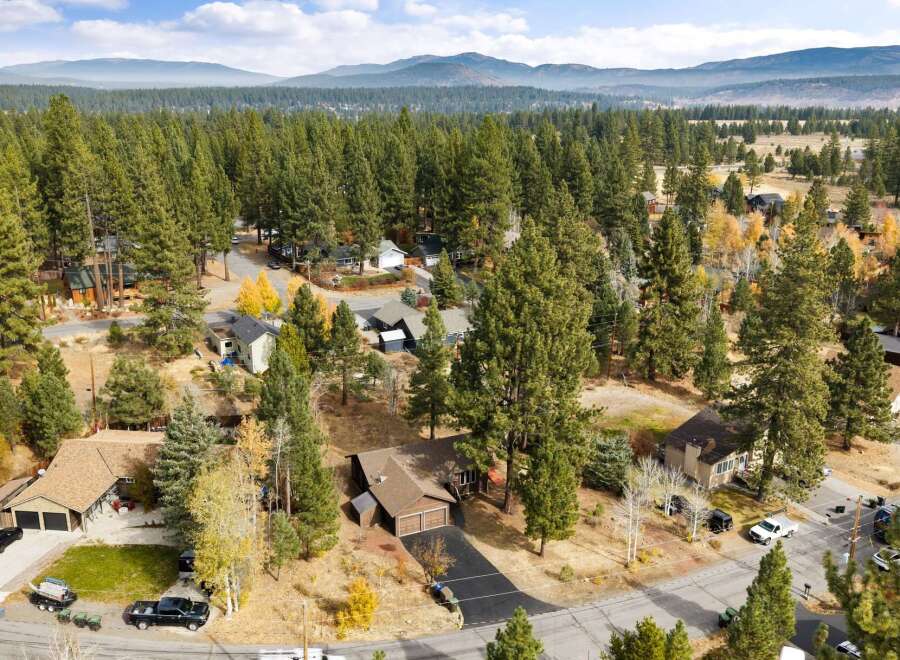 Nestled amidst a dense forest of tall pine trees, this property offers a serene and private retreat.