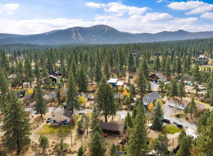 Discover this charming mountain retreat nestled amongst towering pine trees, offering a serene escape with breathtaking views of the surrounding landscape.