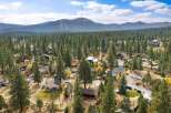 Discover this charming mountain retreat nestled amongst towering pine trees, offering a serene escape with breathtaking views of the surrounding landscape.