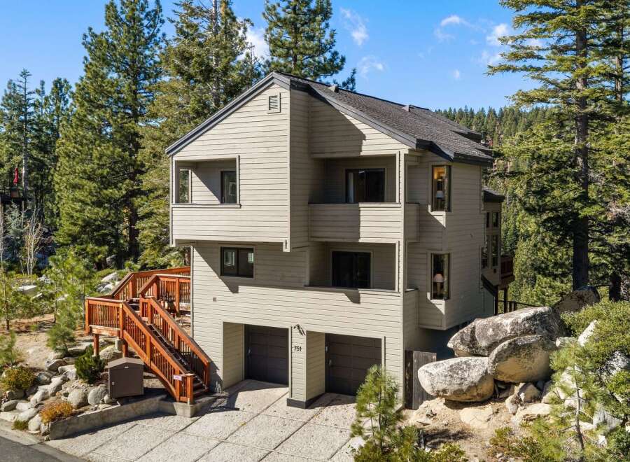 Nestled amidst towering pine trees, this multi-level home offers a serene mountain retreat.