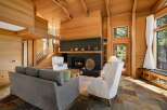 Experience rustic elegance in this stunning living room, featuring a grand dark brick fireplace as the focal point.