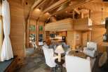 Experience luxurious living in this stunning modern home featuring a soaring vaulted ceiling with exposed wooden beams and extensive natural wood paneling throughout.