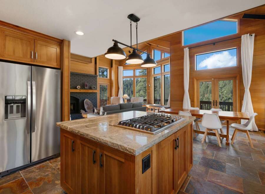 Experience luxury living in this stunning home featuring a gourmet kitchen with a granite island and gas range, perfect for culinary enthusiasts.