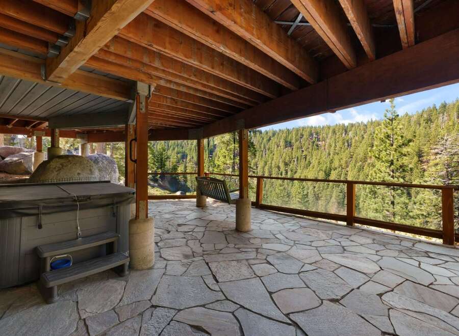 Enjoy the ultimate relaxation with this spacious outdoor patio, featuring a luxurious hot tub perfect for unwinding after a long day.