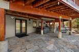 Enjoy outdoor living with this spacious patio featuring a relaxing hot tub and a charming swing bench.