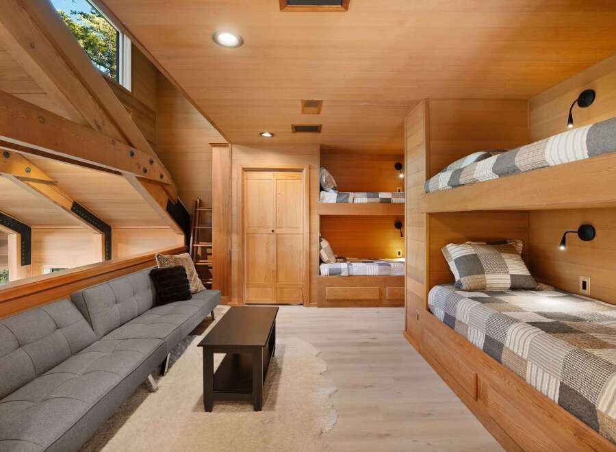 This spacious loft bedroom features multiple built-in bunk beds, perfect for accommodating family and friends.