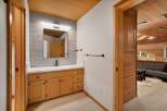 This modern bathroom features a sleek vanity with ample storage and a minimalist black faucet.