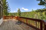 Enjoy breathtaking panoramic views from this expansive wooden deck, perfect for outdoor entertaining or quiet relaxation.