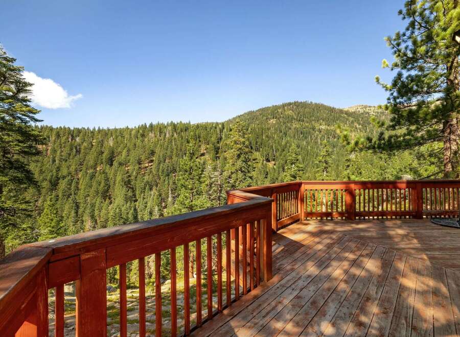 Enjoy breathtaking mountain views from this expansive wooden deck, perfect for outdoor entertaining or quiet relaxation.