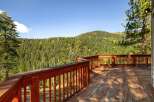 Enjoy breathtaking mountain views from this expansive wooden deck, perfect for outdoor entertaining or quiet relaxation.