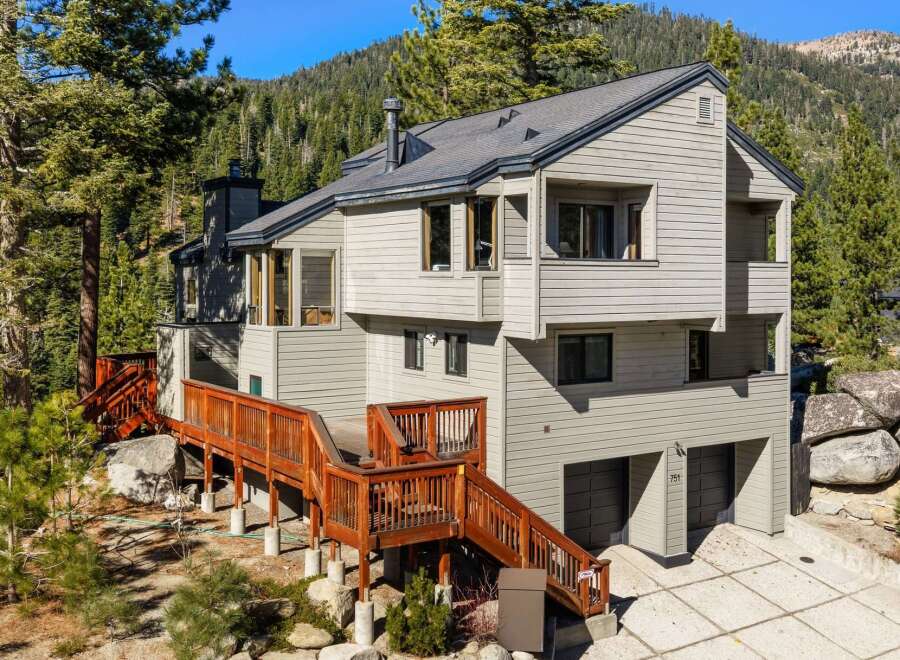 Nestled amidst towering pine trees and majestic boulders, this multi-level home offers a serene mountain retreat.