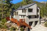 Nestled amidst towering pine trees and majestic boulders, this multi-level home offers a serene mountain retreat.