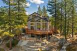 Nestled amidst towering pine trees and surrounded by natural boulders, this stunning multi-level home offers breathtaking views.