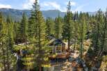 Nestled amidst towering pine trees and large granite boulders, this stunning mountain home offers breathtaking views of the surrounding landscape.
