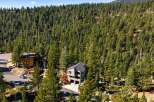 Nestled amidst a dense forest of evergreen trees, this modern home offers a serene and private retreat.