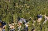 Nestled amidst a dense forest of evergreen trees, this modern home offers a serene and private retreat.