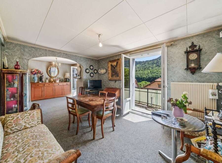 Step into this charming living and dining area, featuring a traditional wooden dining set perfect for family meals.