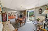 Step into this charming living and dining area, featuring a traditional wooden dining set perfect for family meals.