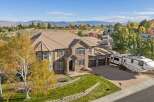 Experience luxury living in this stunning multi-story home, boasting a warm stucco and brick exterior complemented by a durable tile roof.