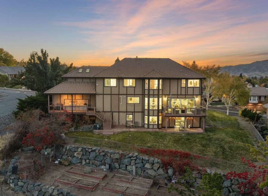 Experience luxury living in this stunning multi-level home, perfectly situated on a hillside with breathtaking sunset views.