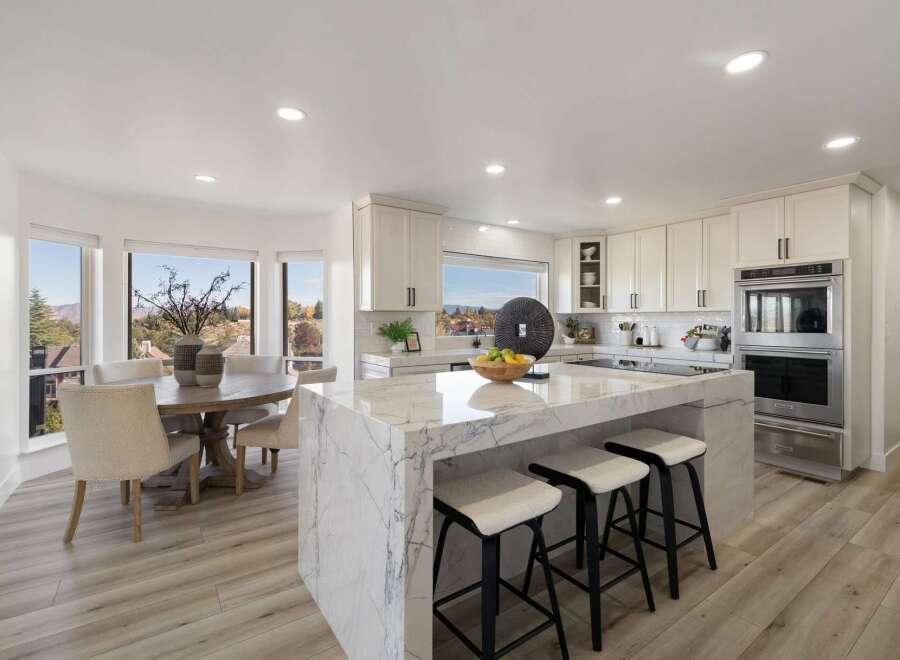 Experience luxury in this stunning modern kitchen, featuring a grand marble island with bar seating perfect for entertaining.