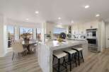 Experience luxury in this stunning modern kitchen, featuring a grand marble island with bar seating perfect for entertaining.