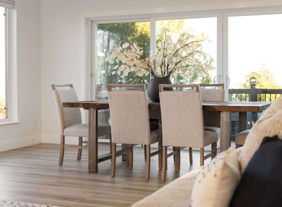 Experience elegant dining in this beautifully appointed space, featuring a rustic wooden table complemented by upholstered chairs.