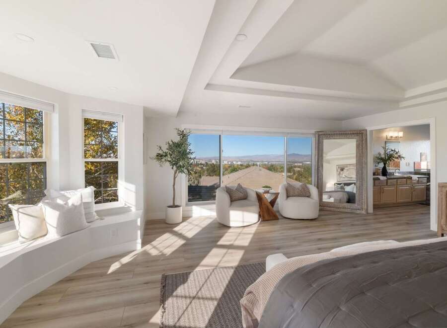 Experience breathtaking panoramic views from this stunning bedroom, featuring a spacious window seat perfect for enjoying the scenery.