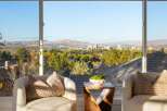Experience breathtaking panoramic views of the city and mountains from this stunning property.
