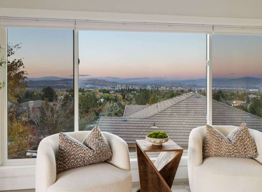 Experience breathtaking panoramic views from this stunning property, showcasing a sprawling cityscape nestled against majestic mountains.
