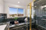 Indulge in relaxation with this luxurious bathroom featuring a deep soaking tub and a separate glass-enclosed shower.