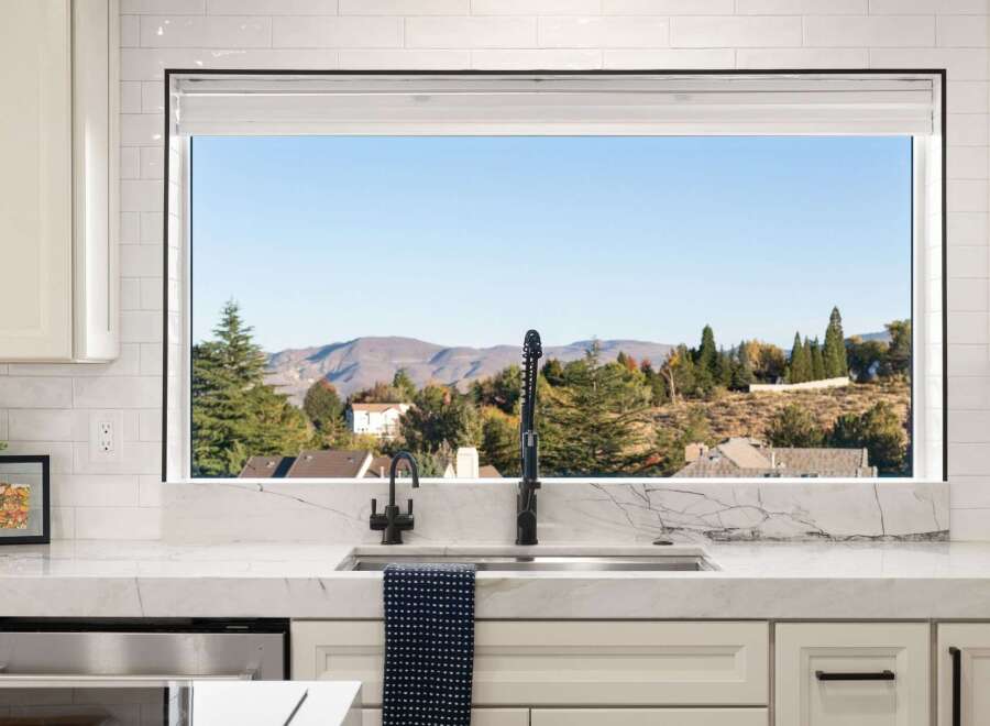 Experience breathtaking mountain views from this stunning kitchen, featuring a large picture window that floods the space with natural light.