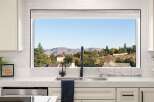Experience breathtaking mountain views from this stunning kitchen, featuring a large picture window that floods the space with natural light.