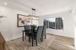 This dining room features a sleek black dining table with four upholstered chairs, perfect for intimate gatherings.