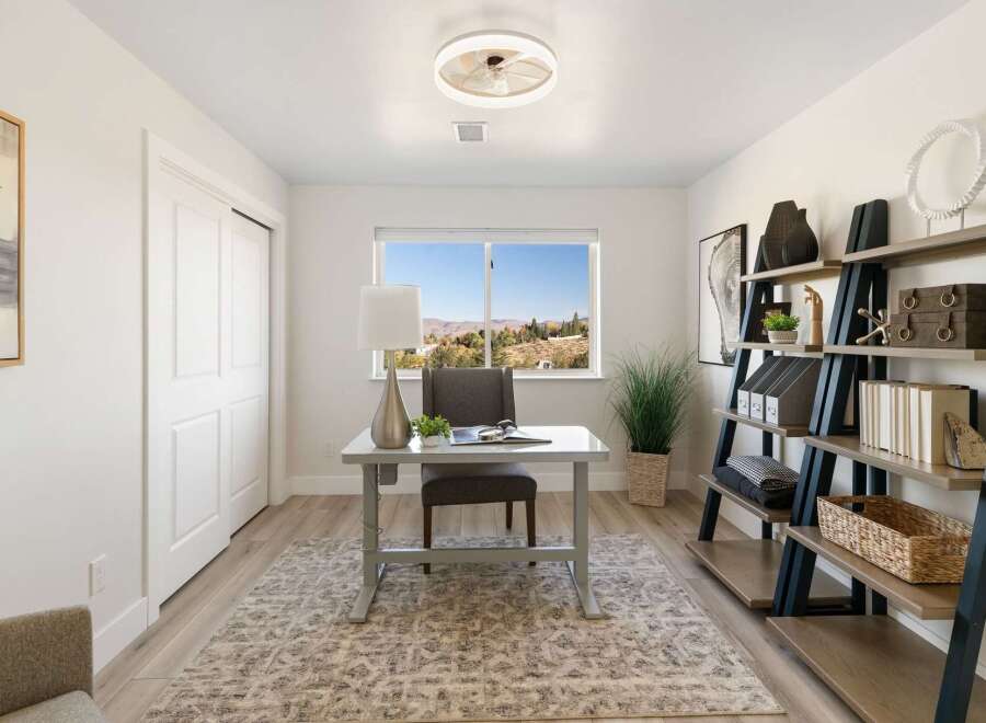 This home office features a sleek desk with a modern lamp, perfect for productivity.
