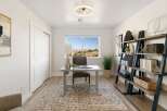 This home office features a sleek desk with a modern lamp, perfect for productivity.