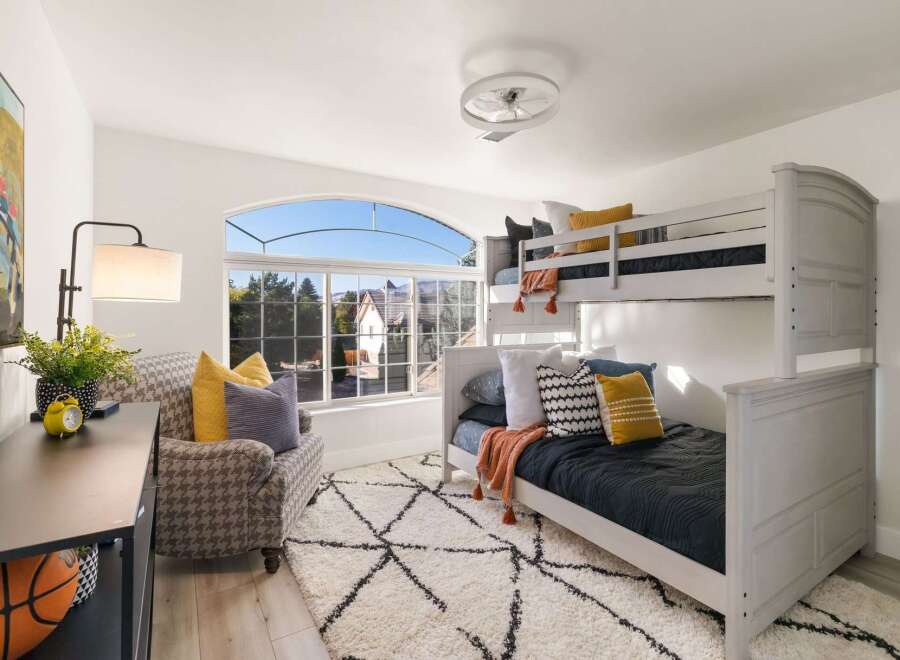 This charming bedroom features a stylish bunk bed, perfect for siblings or sleepovers.