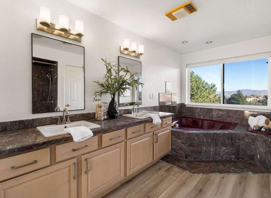 Experience luxury in this stunning bathroom featuring a spacious double vanity with ample counter space and elegant fixtures.