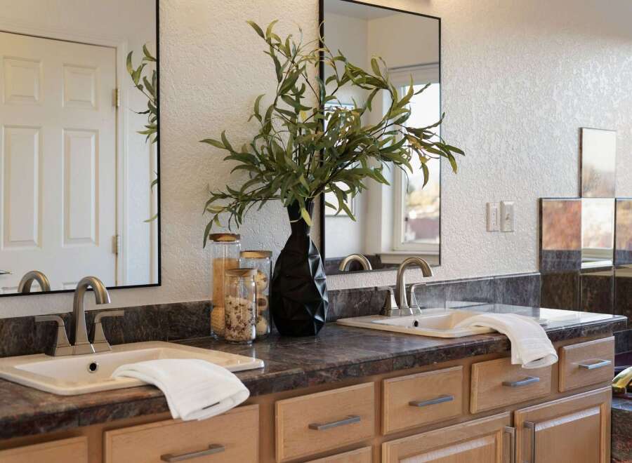 This spacious bathroom features a double vanity with two sinks, each equipped with modern brushed nickel faucets.