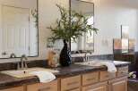 This spacious bathroom features a double vanity with two sinks, each equipped with modern brushed nickel faucets.