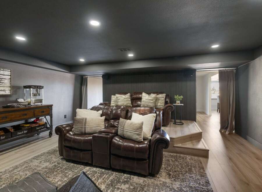 Experience ultimate relaxation in this luxurious home theater, featuring plush leather reclining seats perfect for movie nights.