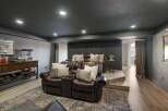 Experience ultimate relaxation in this luxurious home theater, featuring plush leather reclining seats perfect for movie nights.